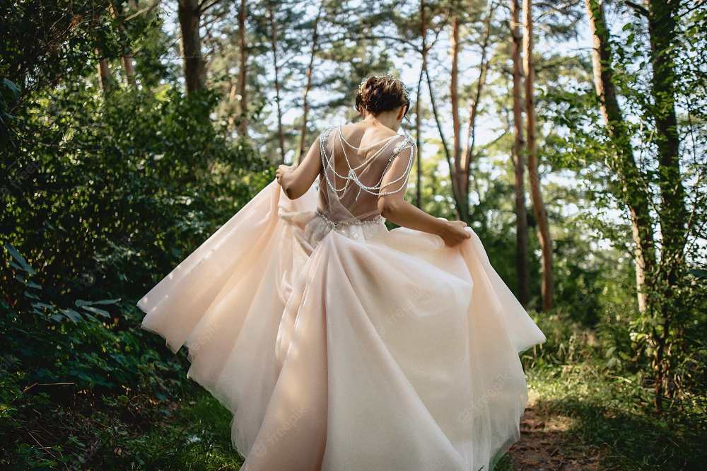 Gorgeous forest wedding gown with a flowing skirt and beautiful embroidery